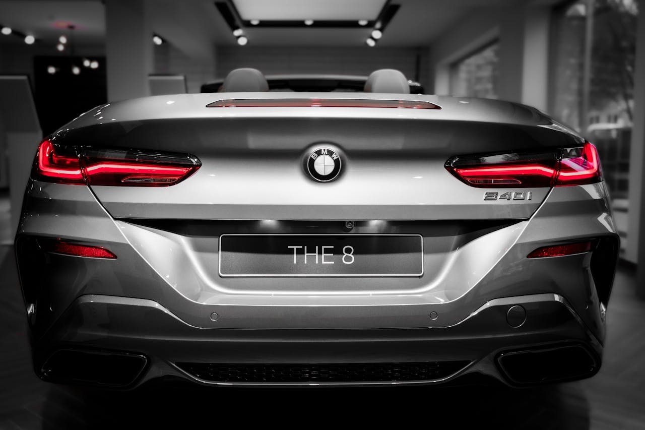 Close-up rear view of a silver BMW 840i showcasing its modern design and bright tail lights.